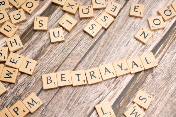 Scrabble laid out to spell the word betrayal